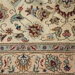 Persian Kashan rug, ivory ground field decorated with an all-over design of scrolling vines and stylized palmettes in pastel tones and conforming floral borders
