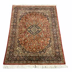 Persian Keshan red and blue ground rug, the field and border decorated with scrolling foliate and stylised flower heads, central medallion 
