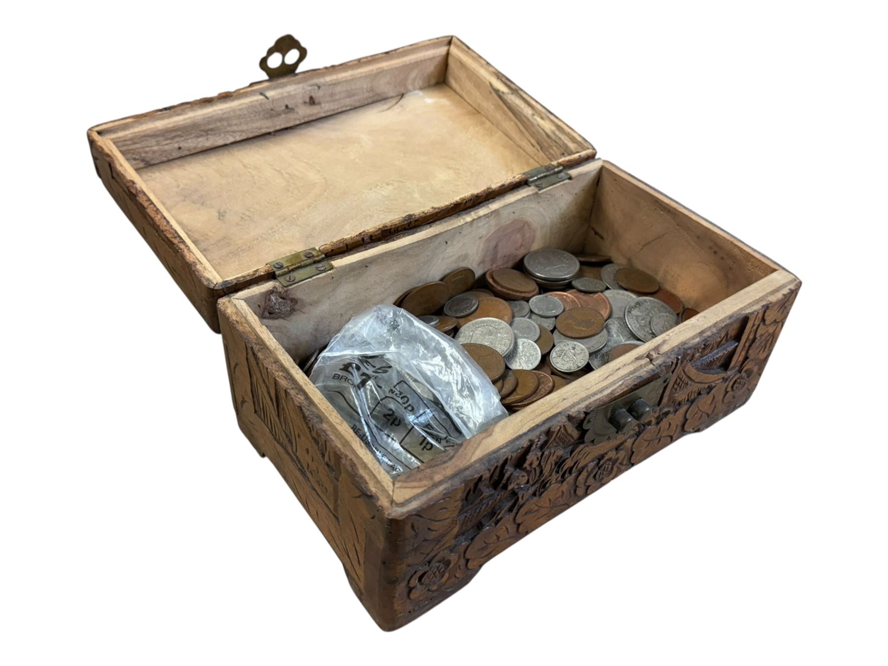 Approximately 115 grams of Great British pre-1947 silver coins, and further pre-decimal coins, housed in a miniature carved camphor wood chest