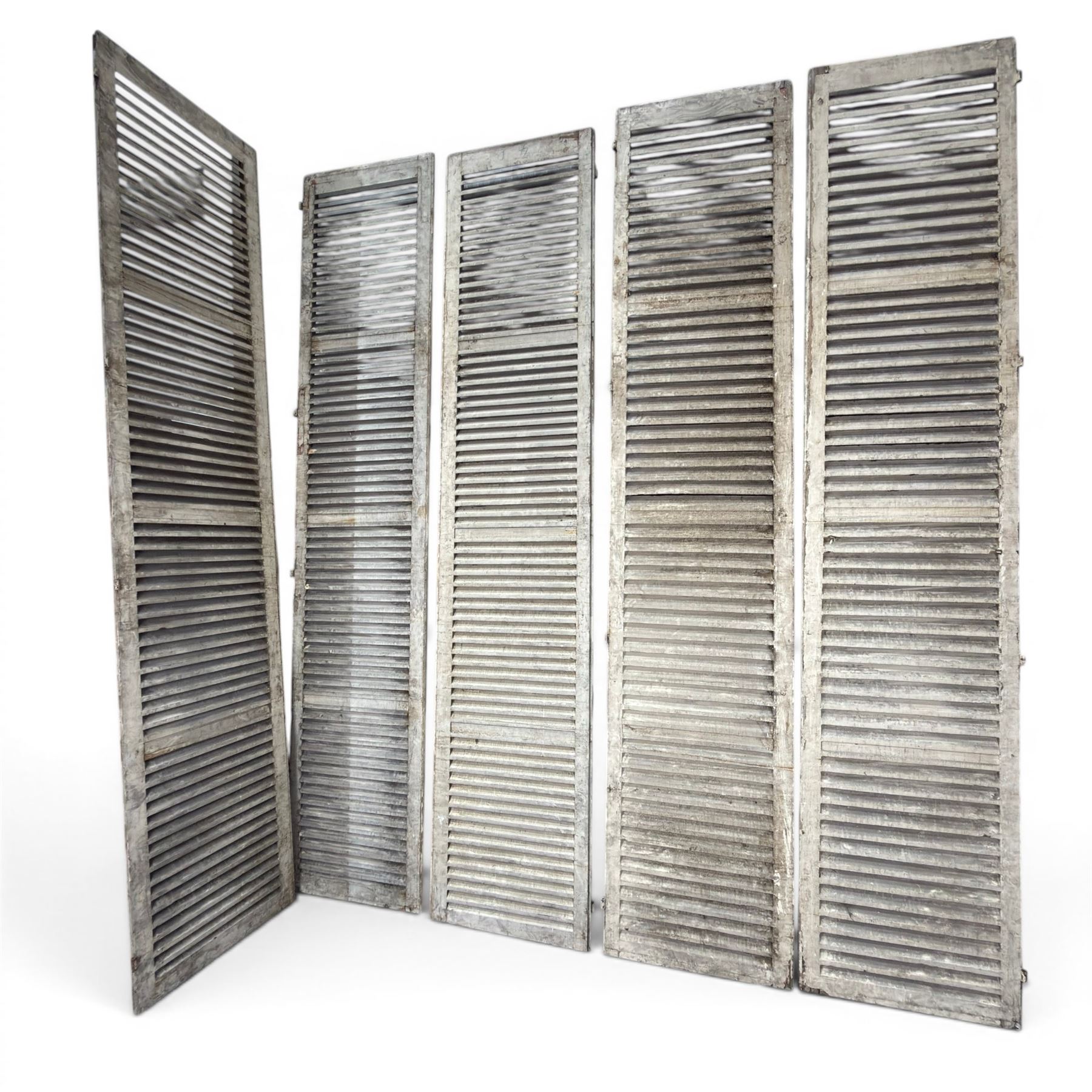 Five 19th century full height French Chateau louvre doors, pitch pine painted in cream finish, two having iron rod hinges, dimensions approx.