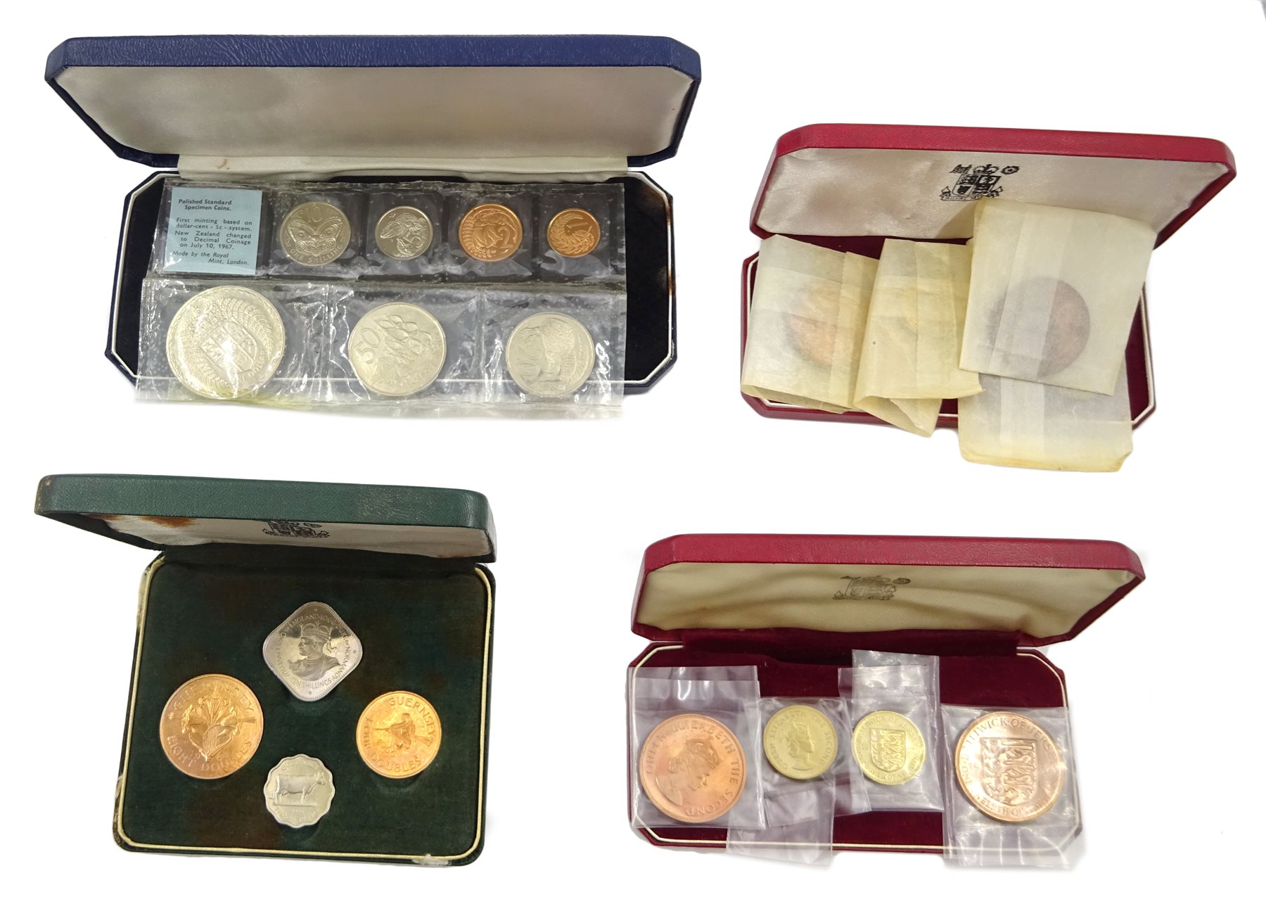  Bailiwick of Jersey 1957 cased four coin set and 1964 cased four coin set, Guernsey 1966 cased four coin set and New Zealand 1967 decimal coins cased seven coin set with coins still sealed in plastic packaging (4)   