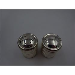 Pair of modern silver salt and pepper shakers, of cylindrical form, each with ridged band decoration, hallmarked Laurence R Watson & Co, Birmingham 2003, H 4cm, boxed 