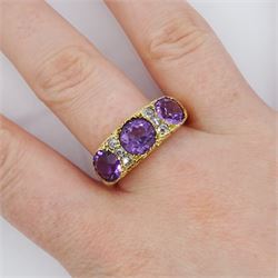 Dutch gold three stone round cut amethyst and six old cut diamond ring, stamped, total amethyst weight approx 3.95 carat