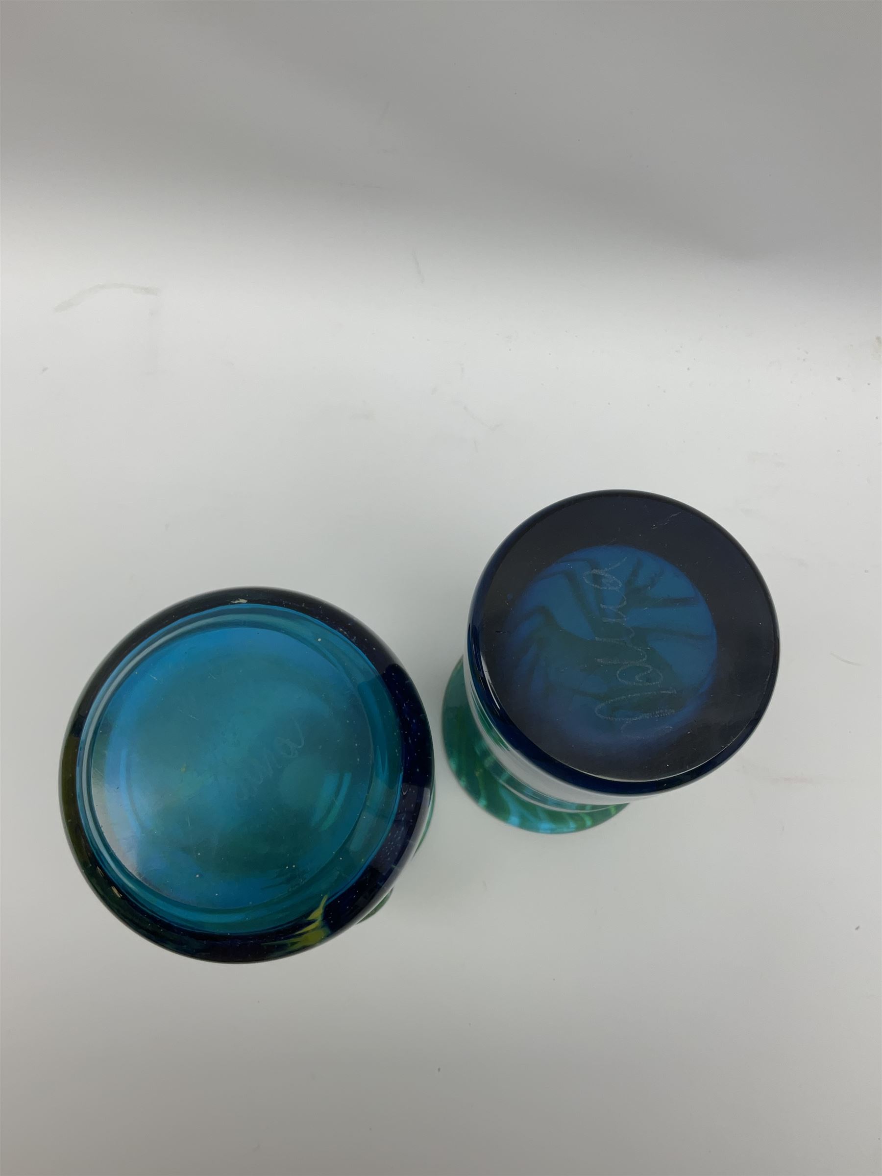 Quantity of M’dina art glass to include a streaked blue and green bottle form vase with captured bubble design and slender neck, H35cm, along with a paperweight, ovoid form vase and another vase all decorated in a blue, brown and white colour way, other contemporary glass examples etc with etched marks beneath