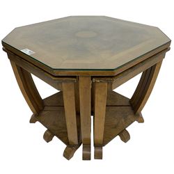 1930s Art Deco period walnut nest of tables, square canted top with segmental figured veneers forming flowerhead with birdseye maple centre, with four smaller nesting tables on arched supports united by undertier, on block feet