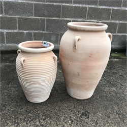  Large terracotta flagon (H70cm) and a similar smaller ribbed flagon (H53cm) (2)  