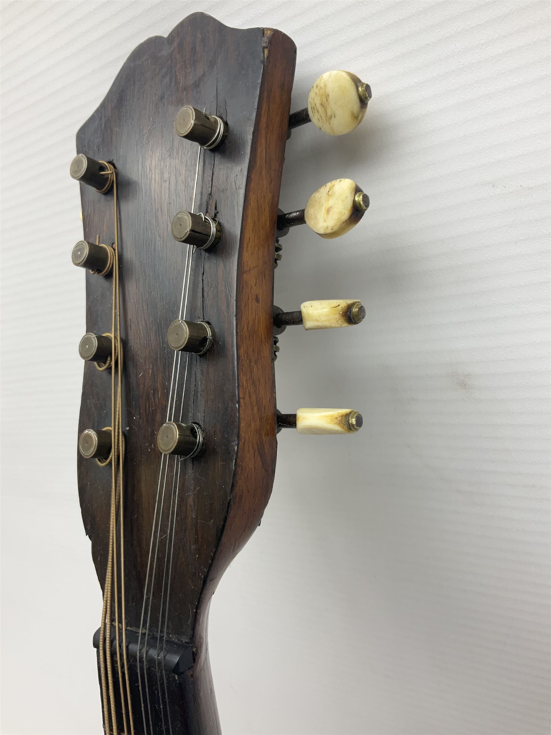 Late 19th century Italian lute back mandolin with segmented bowl back, bears label Gennaro Maglioni Napoli L61cm; in ebonised wooden case; together with another similar damaged Italian lute back mandolin for restoration or spares (2)
