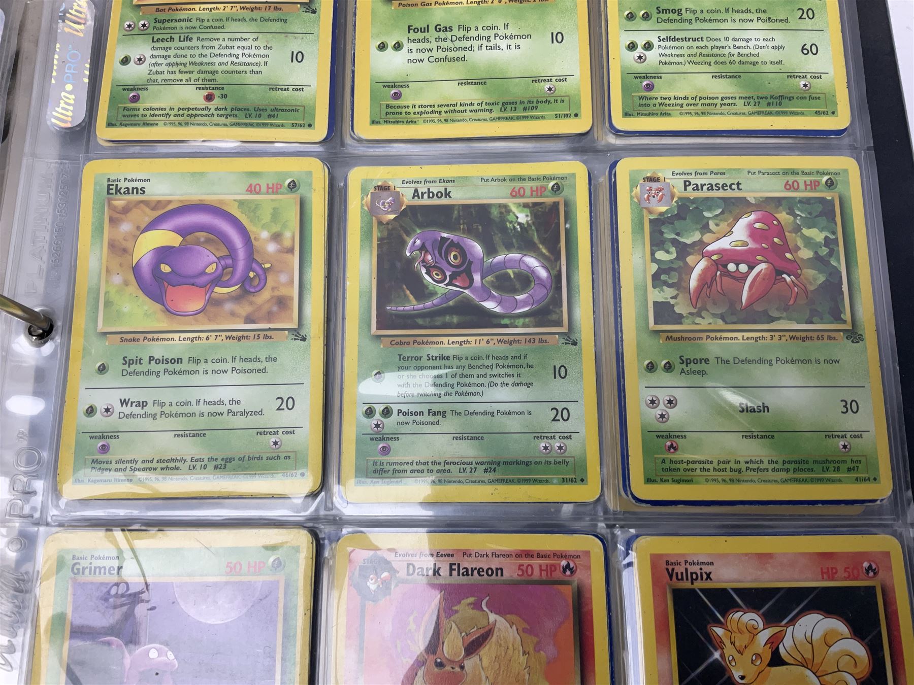 Collection of Pokemon trading cards, mostly 1999 Wizards Pokemon cards to include holo Charizard 4/102, first edition holo Machamp 8/102, further holographic cards; Dark Flareon 35/82 and Dark Vaporeon 45/82, cards from themed sets and 4th edition prints; 1998 Electronic Pokédex with cardboard boxes for themed decks Blackout, Overgrowth and Power Reserve Jungle, along with a large quantity of energy and trainer cards 