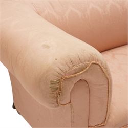 Victorian two seat sofa, upholstered in pink fabric, bowed form with scroll back and arms, raised on turned legs with castors