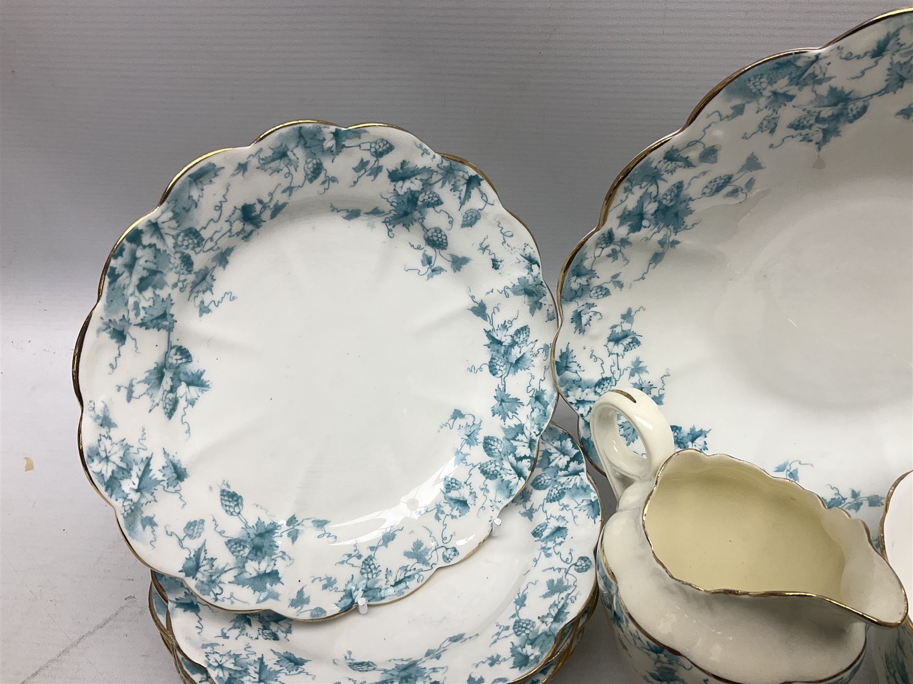Edwardian David Chapman & Sons tea service for six, of lobed form decorated with blue transfer printed foliate decoration and gilt rims