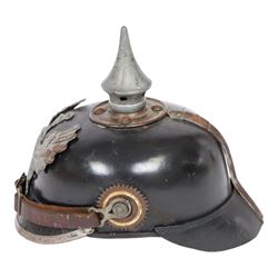 WWI Prussian M1915 Pickelhaube, the black leather skull with removable steel spike finial, steel eagle helmet plate and leather chin strap, one side with a black cockade, the other black and red