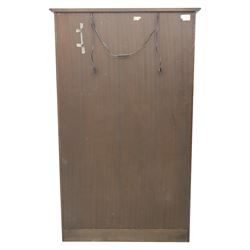 Mid 20th century oak display cabinet, the moulded rectangular cornice above a pair of leaded glazed doors with diamond lattice glazing, enclosing adjustable shelving, the lower section fitted with four short drawers with brass ring handles, flanked by chamfered uprights with carved leaf detail