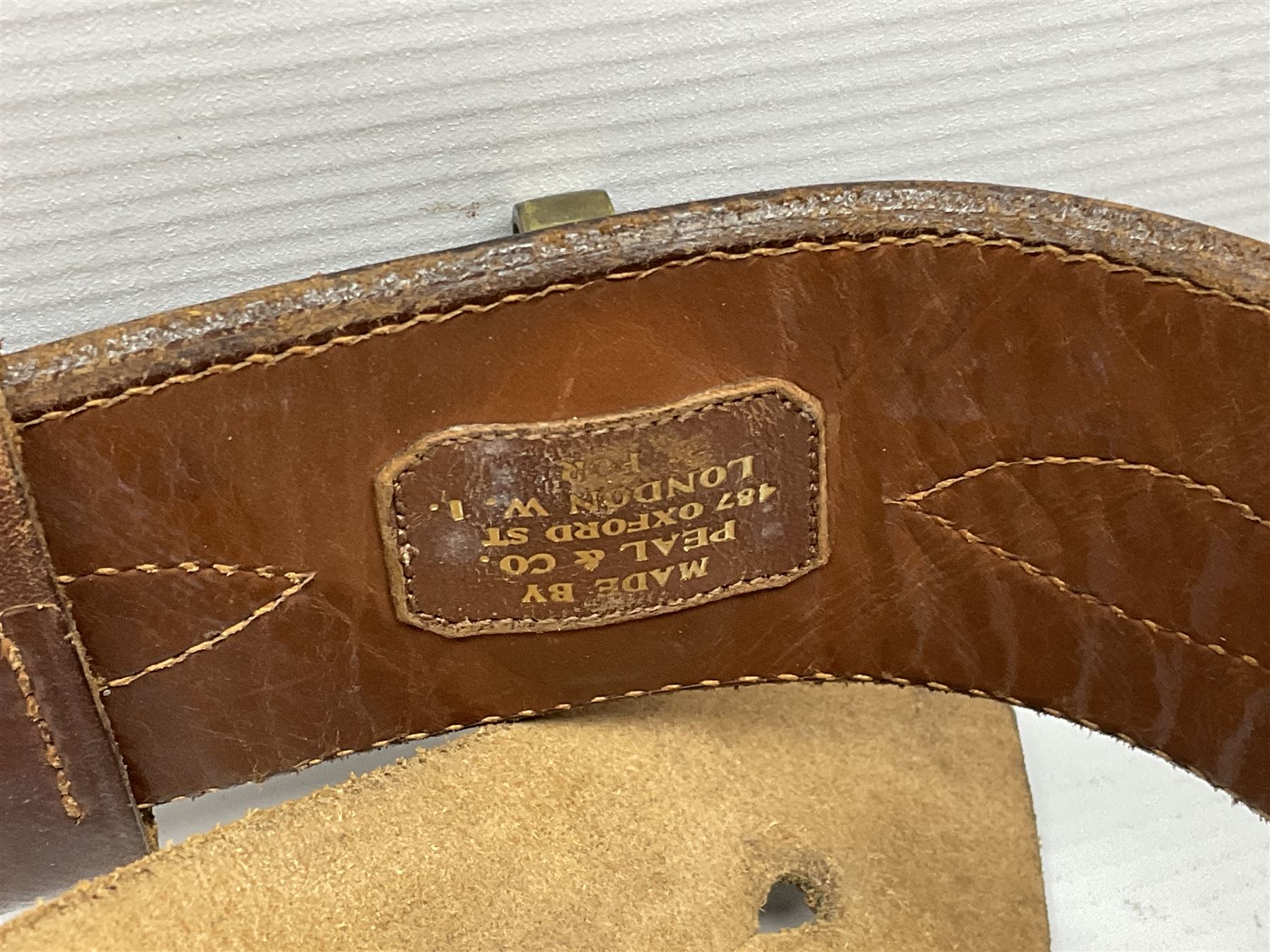 British Army General Staff officer's peaked cap by Herbert Johnson London in Moss Bros. delivery box; two officer's Sam Browne leather belts; leather pistol holster and sword hanger; pair of leather gloves and pair of spurs