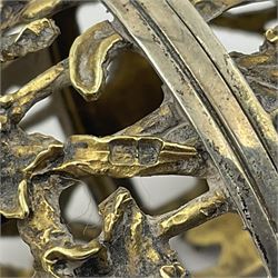 Modern silver limited edition Easter egg, no. 70/500, the gilt openwork body decorated with daffodils and detachable cover with pierced circular panel set with a single faceted blue stone, opening to reveal a gilt interior, upon silver stand with three scrolling pad feet, each hallmarked St James House Company, London 1980, height including stand 8cm