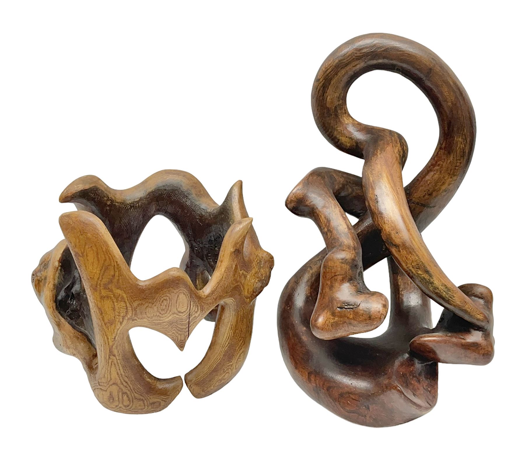 Helen Skelton (British 1933 – 2023): Two carved wooden abstract sculptures, one modelled as a entwined knot, largest H48cm. Born into an RAF family in 1933 in Kent and travelled the world extensively during her childhood. After settling in Bridlington, Helen immersed herself in painting, textiles, and wood sculpture, often inspired by nature's beauty. Her talent was showcased in a one-woman show at Sewerby Hall and recognised with the sculpture prize at Ferens Art Gallery in 2000. Sadly, Helen’s daughter passed away from cancer in 2005. This loss inspired Helen to donate her sculptures to Marie Curie upon her passing in 2023.