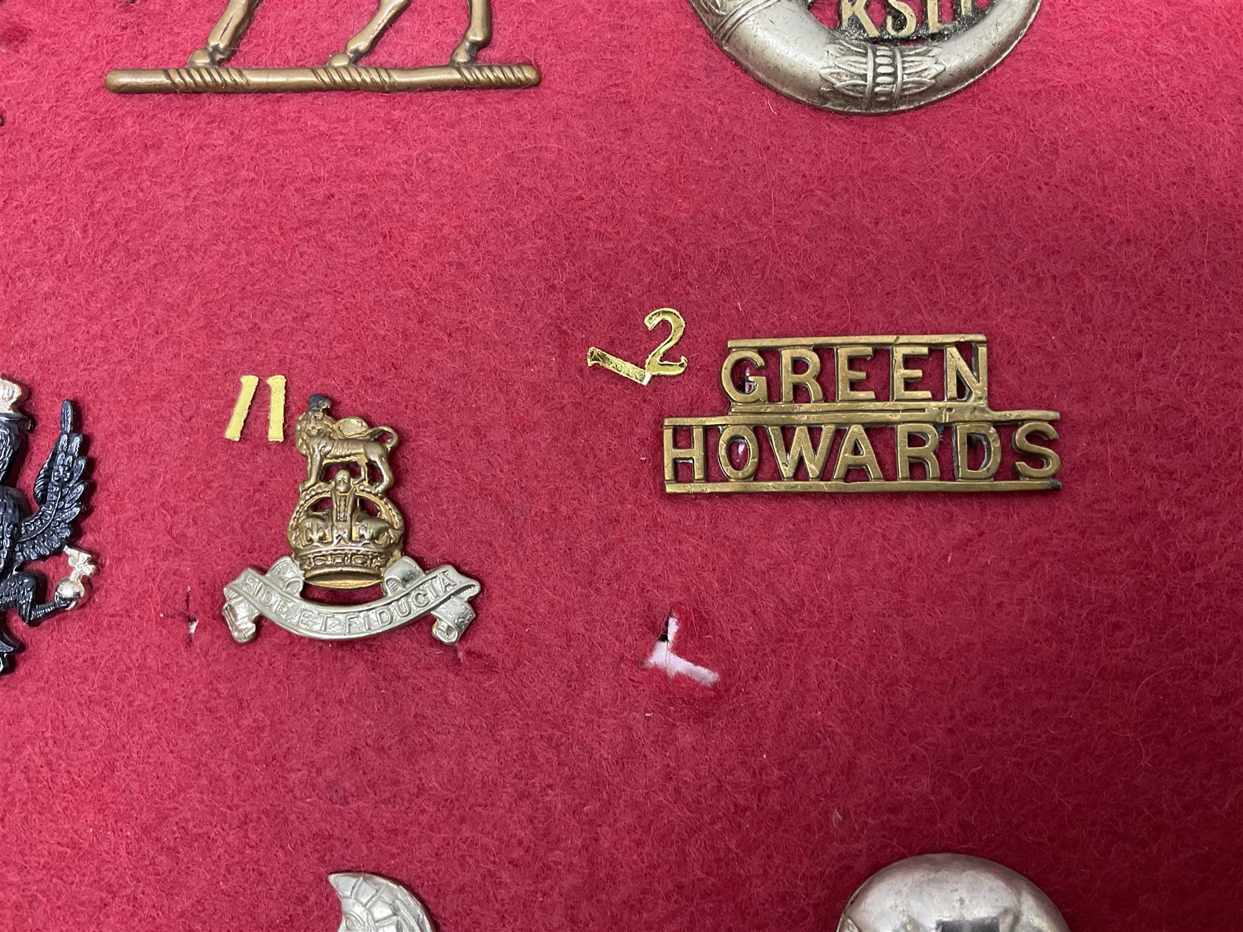 Forty glengarry and cap badges and shoulder titles including Gordon Highlanders, Canada and Canadian Field Artillery, New Zealand Field Artillery and Rifle Regiment, Shropshire Light Infantry, 14th/20th Kings Hussars, 17th Lancers, Northamptonshire Yeomanry, Royal Lincolnshire, Special Air Service, 19th Alexandra P.W.O. Hussars etc; mounted on two boards for display (2)