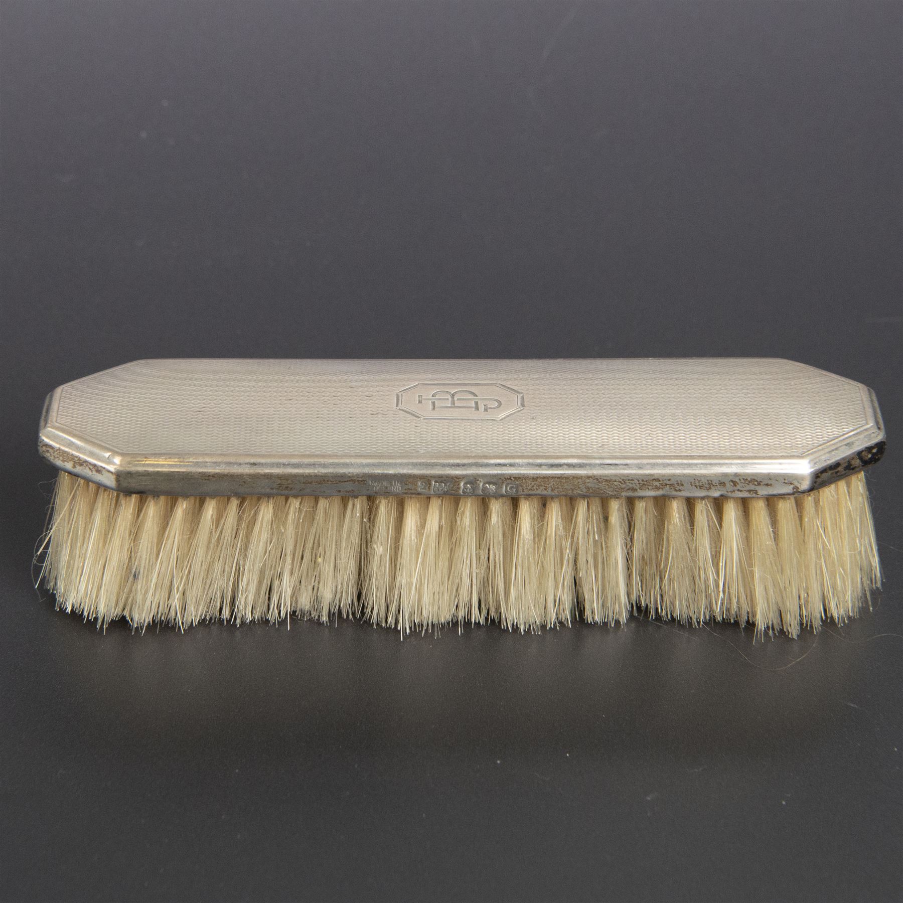 1930s silver mounted three piece dressing table set, comprising hand mirror, hair brush and clothes brush, hallmarked Barker Brothers Silver Ltd, Birmingham 1931