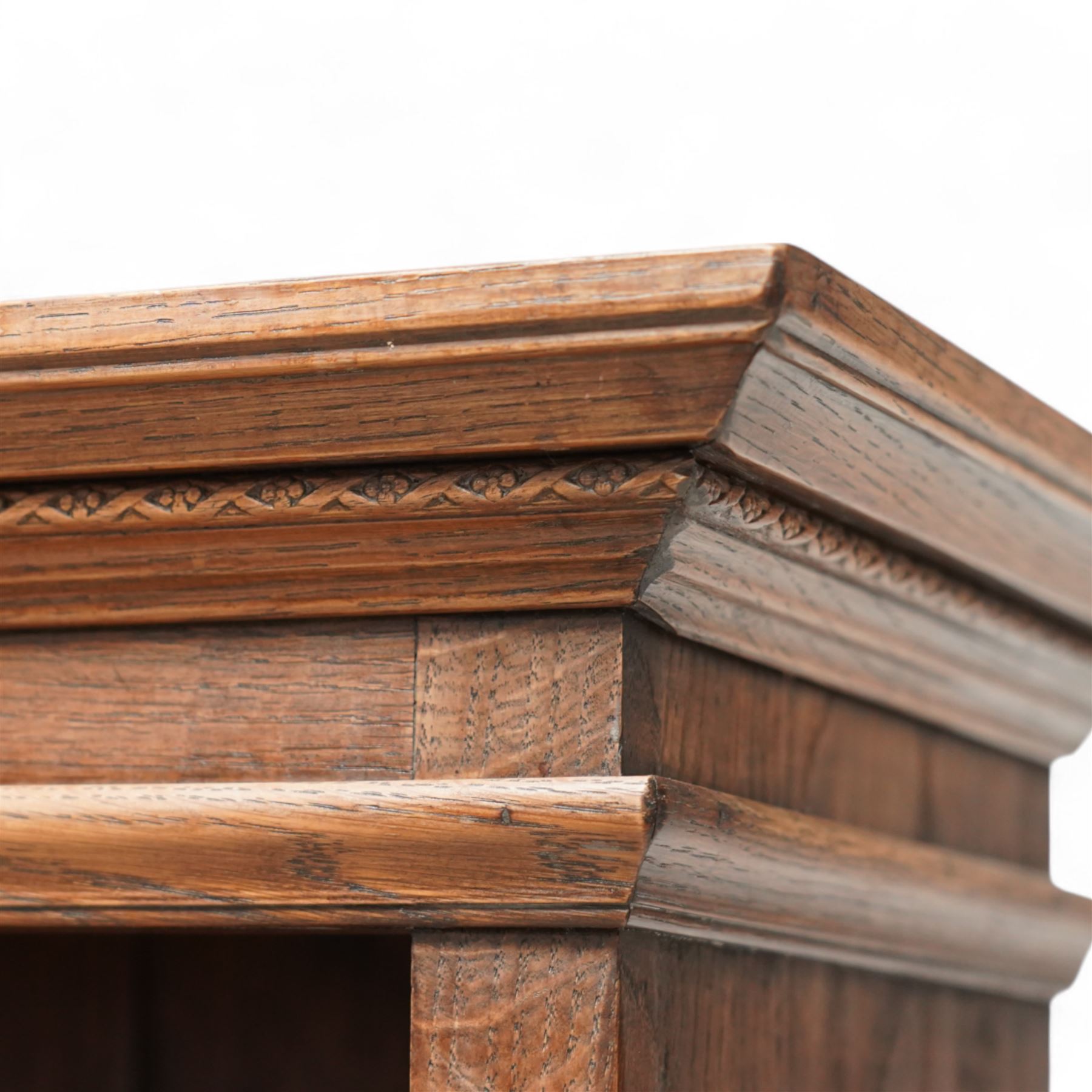 Oak open bookcase, projecting cornice over open front fitted with adjustable shelves, fluted uprights, on shaped bracket feet 