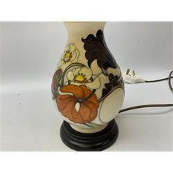 Moorcroft table lamp, of baluster form, decorated with tulips and other flowers upon a white ground with accompanying cream shade of lobed form, with piped detail, H45cm
