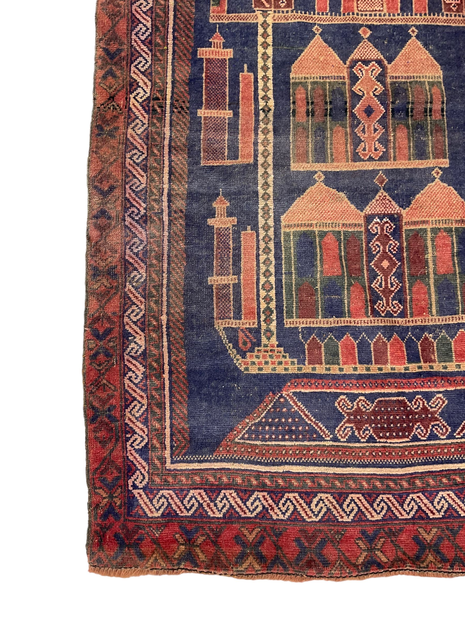 Persian Baluchi prayer rug, blue ground field decorated with Mosque and cityscape, the border with repeating geometric designs 