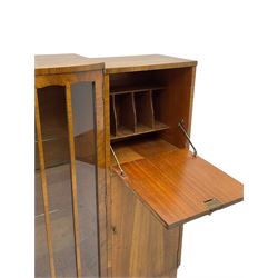 Early 20th century walnut side cabinet, enclosed by central bowed and glazed door, fitted with drawer, two cupboards and fall front, on plinth base