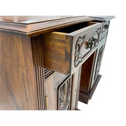 Pair Victorian style hardwood bedside cabinets, fitted with single drawer and cupboard, the doors carved with floral urns, on plinth bases
