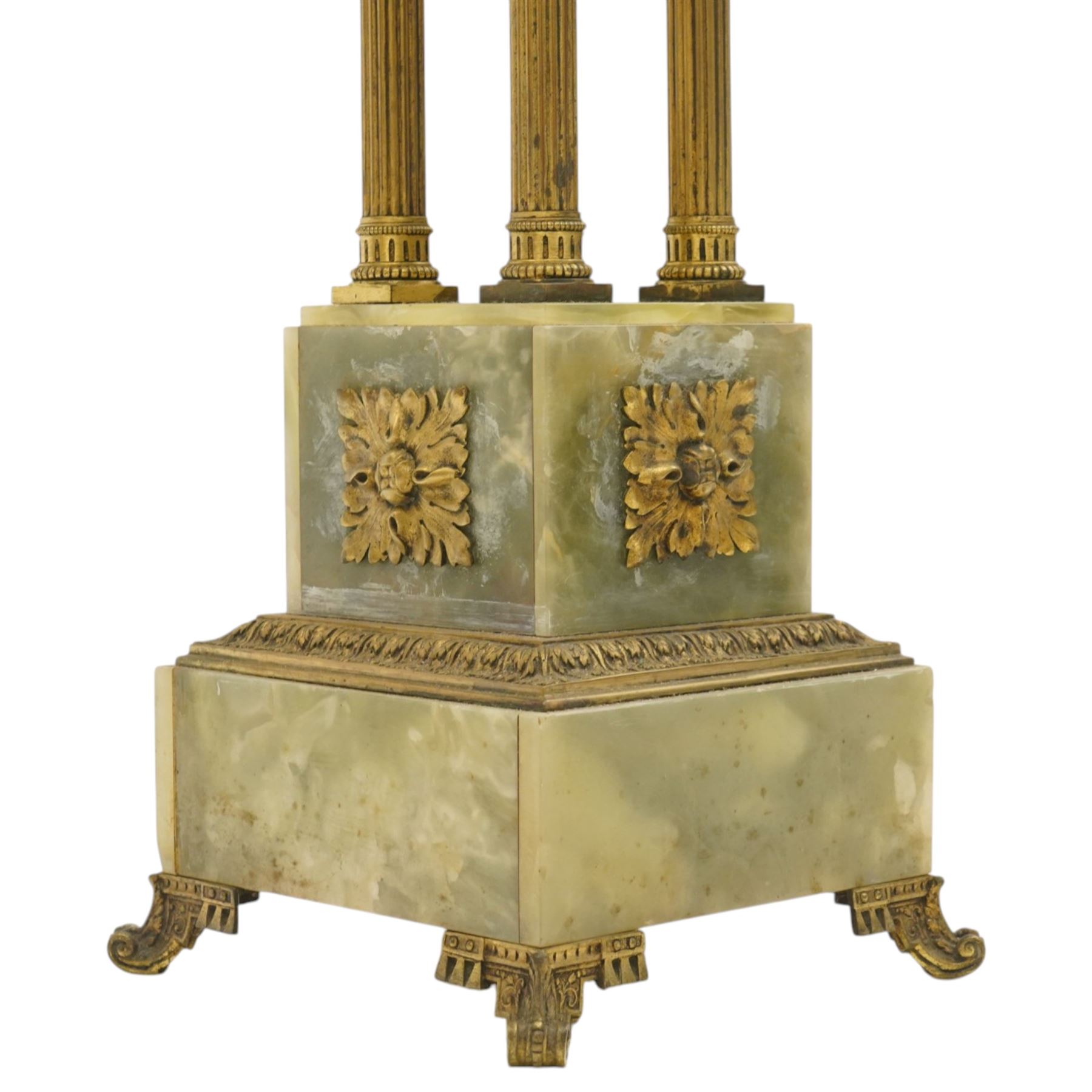 Neoclassical onyx and brass jardinière or plant stand, circular onyx top over an acanthus gilt frieze, supported by for fluted composite columns, square plinth with applied rosette mounts and stepped base, raised on scroll feet  
