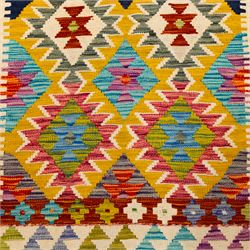 Afghan Chobi kilim flatweave runner with a repeating stepped diamond medallion design in live green, sky blue, rust, teal, purple, and ivory, framed by geometric borders in tones of orange and crimson