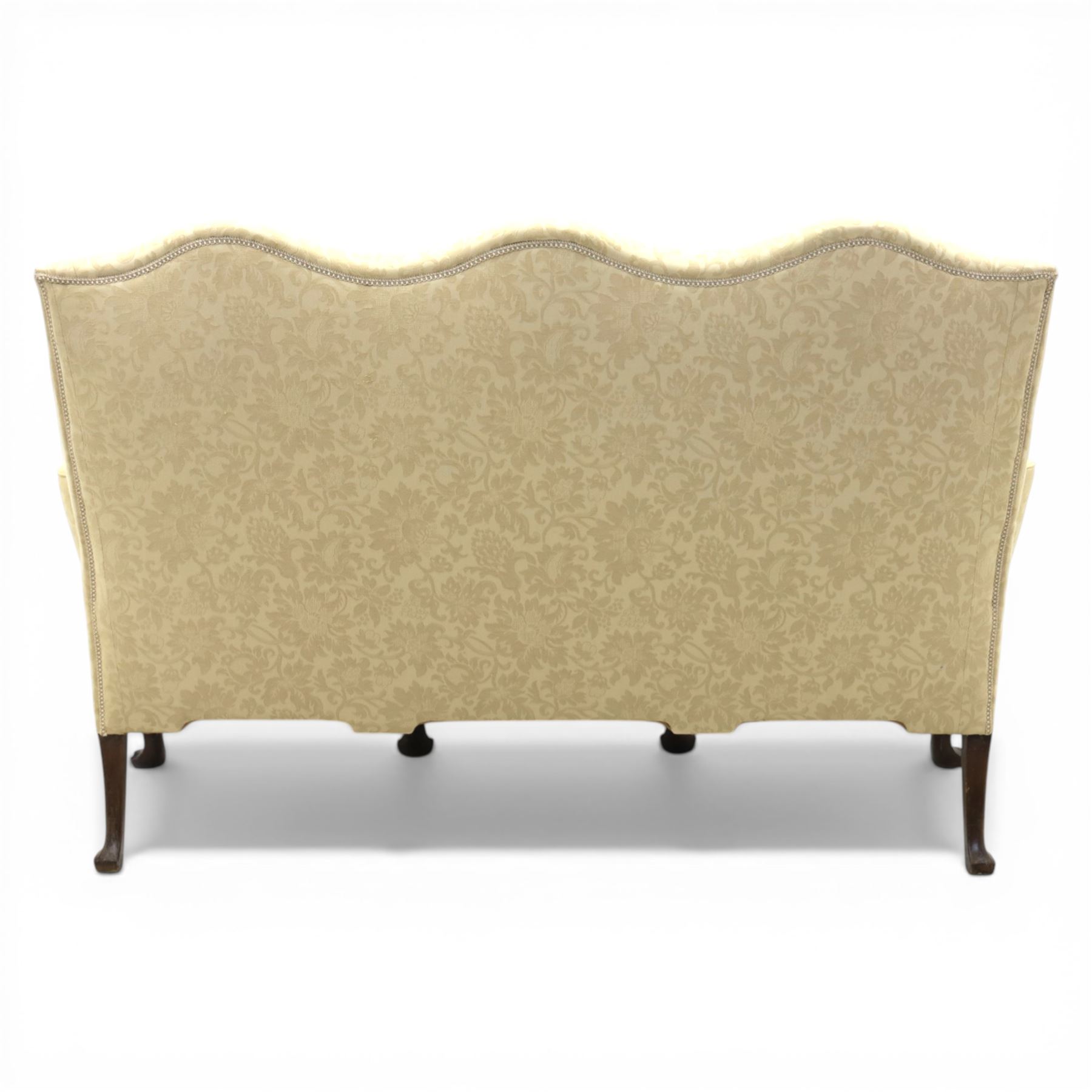 19th century Queen Anne style cream foliate upholstered three seat settee, the shaped and waisted back with serpentine cresting, padded arms over loose seat cushions, raised upon carved cabriole supports with shell carved knees