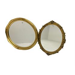 Gilt framed wall mirror, oval bevelled plate with cartouche and scroll detail, with another similar (2)