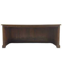 Illingworth Ingham and Co. School Furnishers (Leeds c1900) - early 20th century oak rostrum or headmaster's desk, rectangular top, the front and sides panelled with open reverse, on plinth base