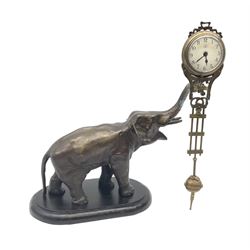 A spelter mystery clock modelled as an elephant supporting the clock upon its trunk, the white circular dial with black Arabic numerals, H26.5cm. 