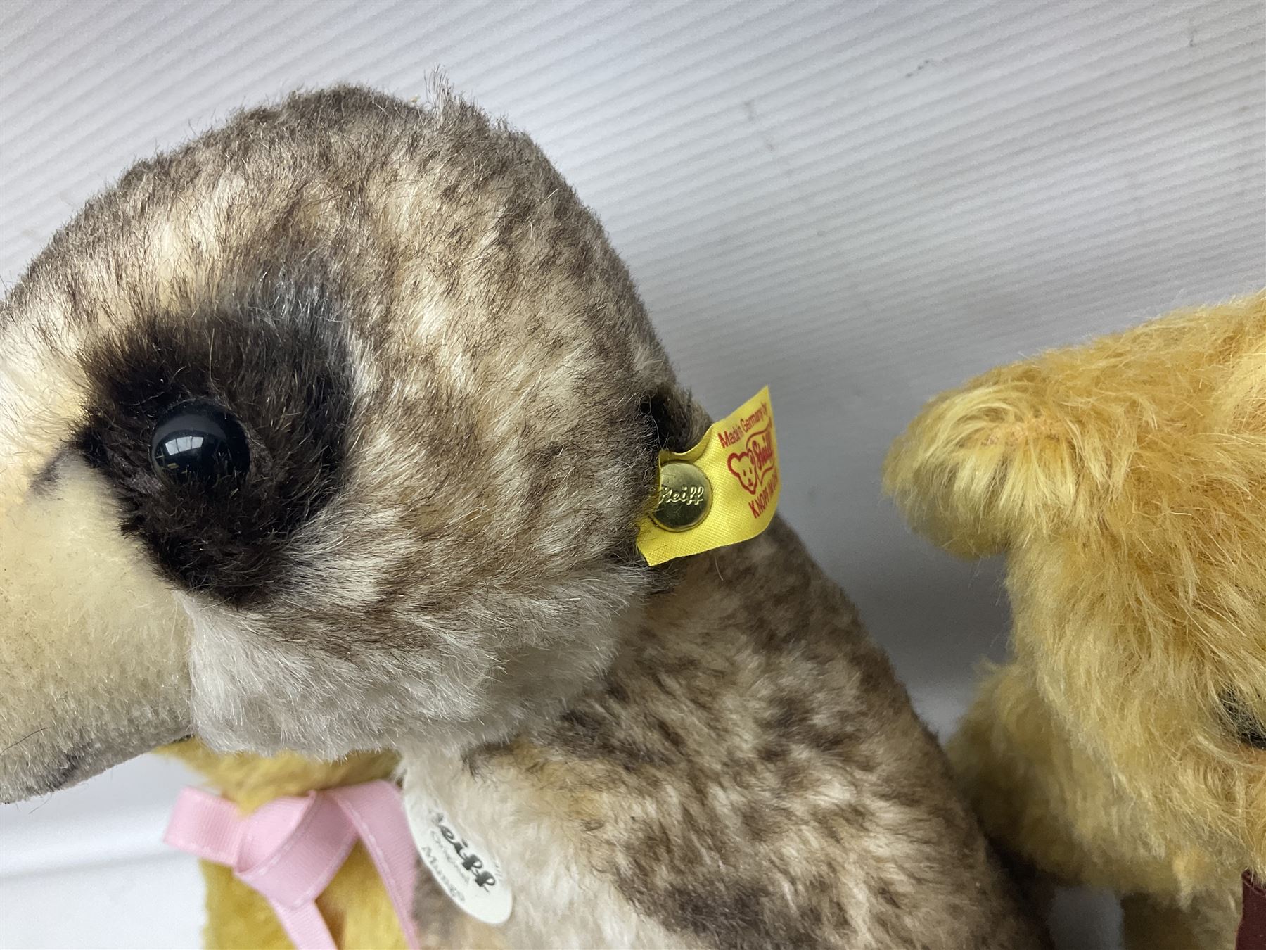 Seven modern Steiff teddy bears comprising two limited edition '1908 Paul the Growler' bears Nos.1124/3000 and 1310/3000; 028649 Classic Teddybear 23; 005992 Classic Teddybear 28 (black); 071249 Mungo Meerkat 30; 079139 Reclining dog for American Kennel Club; and 029561 Petsy gespitzt (1928) 16cm; together with a Mrs. McCatty's limited edition 2156 Sophie bear No.1557/1750; all unboxed but most with labels (8)