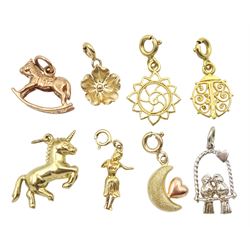 Three 14ct gold charms including hula girl, filigree bug and sun and five 9ct gold charms including unicorn, rocking horse, love birds, flower and moon, all stamped or hallmarked