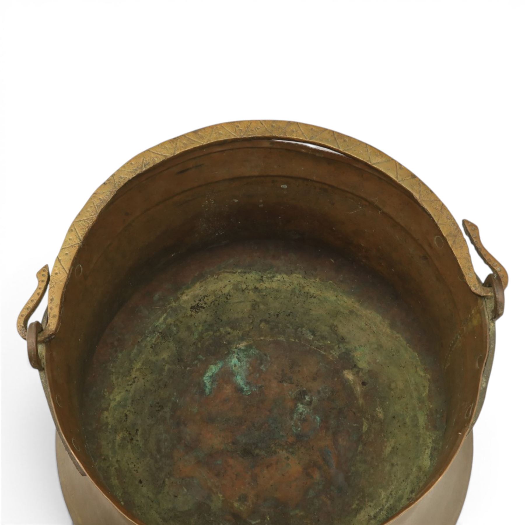 19th century brass and copper cauldron, circular open body with rolled rim, riveted side mounts and swing carrying handle, on broad flared circular foot
