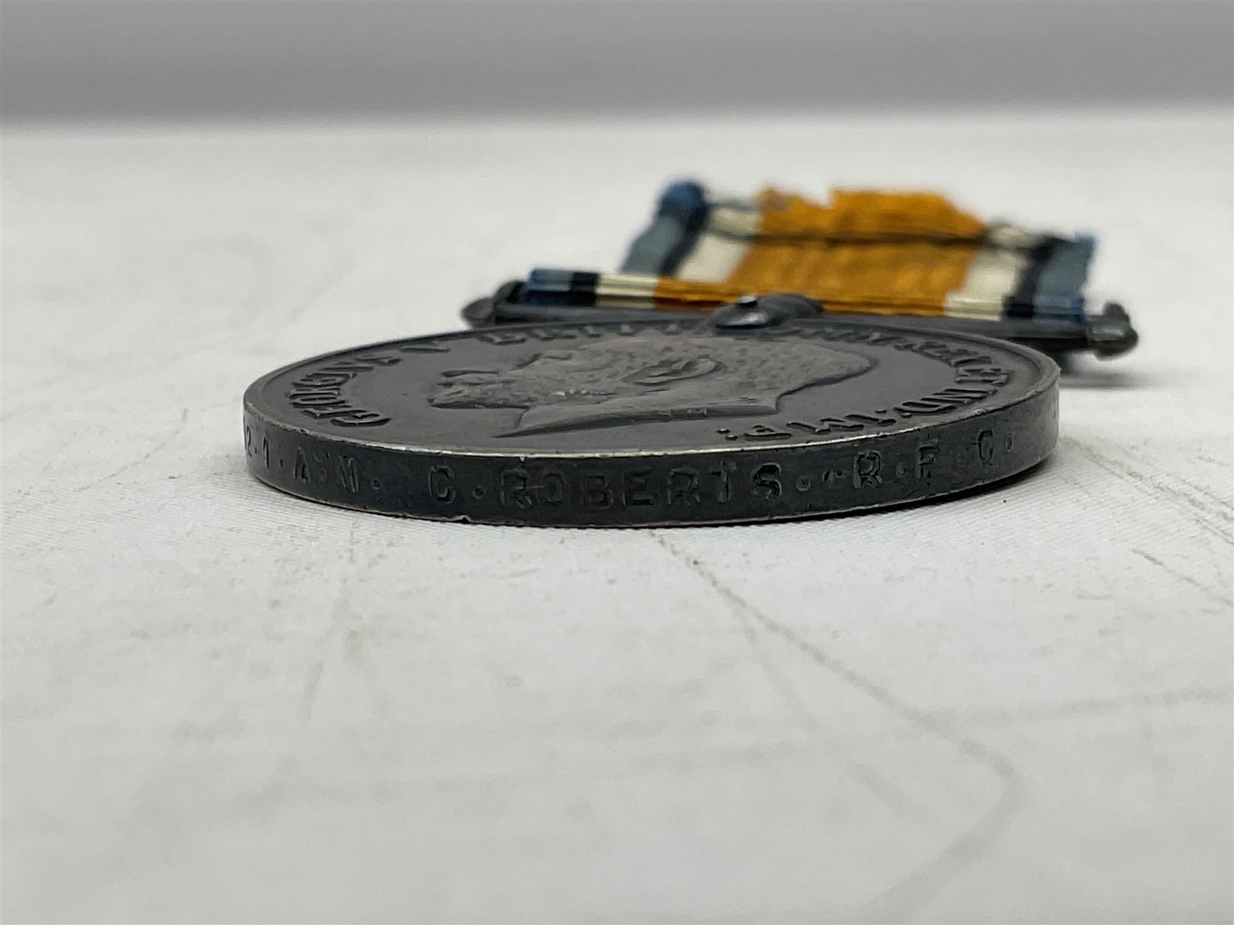 Three WW1 medals comprising 1914-15 Star awarded to 58648 Spr. C. Roberts R.E.; British War Medal and Victory Medal awarded to 87502 1.A.M. C. Roberts R.F.C.; and REME cap badge (4)