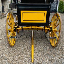Roof Seat Break by Shanks of London

A roof seat break by Shanks of London built on a perch in black and yellow livery, the body fitted with an elevated driver's box seat, elevated rear groom's seat and central passenger compartment. The carriage is mounted on wooden spoked wheels with leaf spring suspension and is equipped with louvred underbody storage compartments, carriage lamp brackets (lamps next lot), folding access steps and a pole for driving with a pair or team of horses. The wheel hubs are stamped 