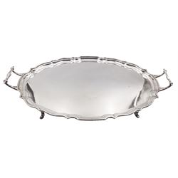 1930's silver twin handled tray, of oval form with pie crust rim, upon four stepped pad feet, hallmarked Barker Brothers Silver Ltd, Birmingham 1933, including handles H7cm, L51.7cm, W31cm, approximate weight 54.68 ozt (1700.8 grams)