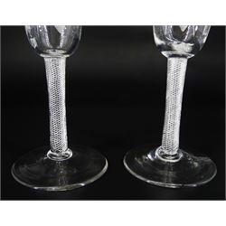Pair of 18th century ale glasses, the funnel bowls engraved with hops and barley, upon single series air twist stems and conical feet, H18cm