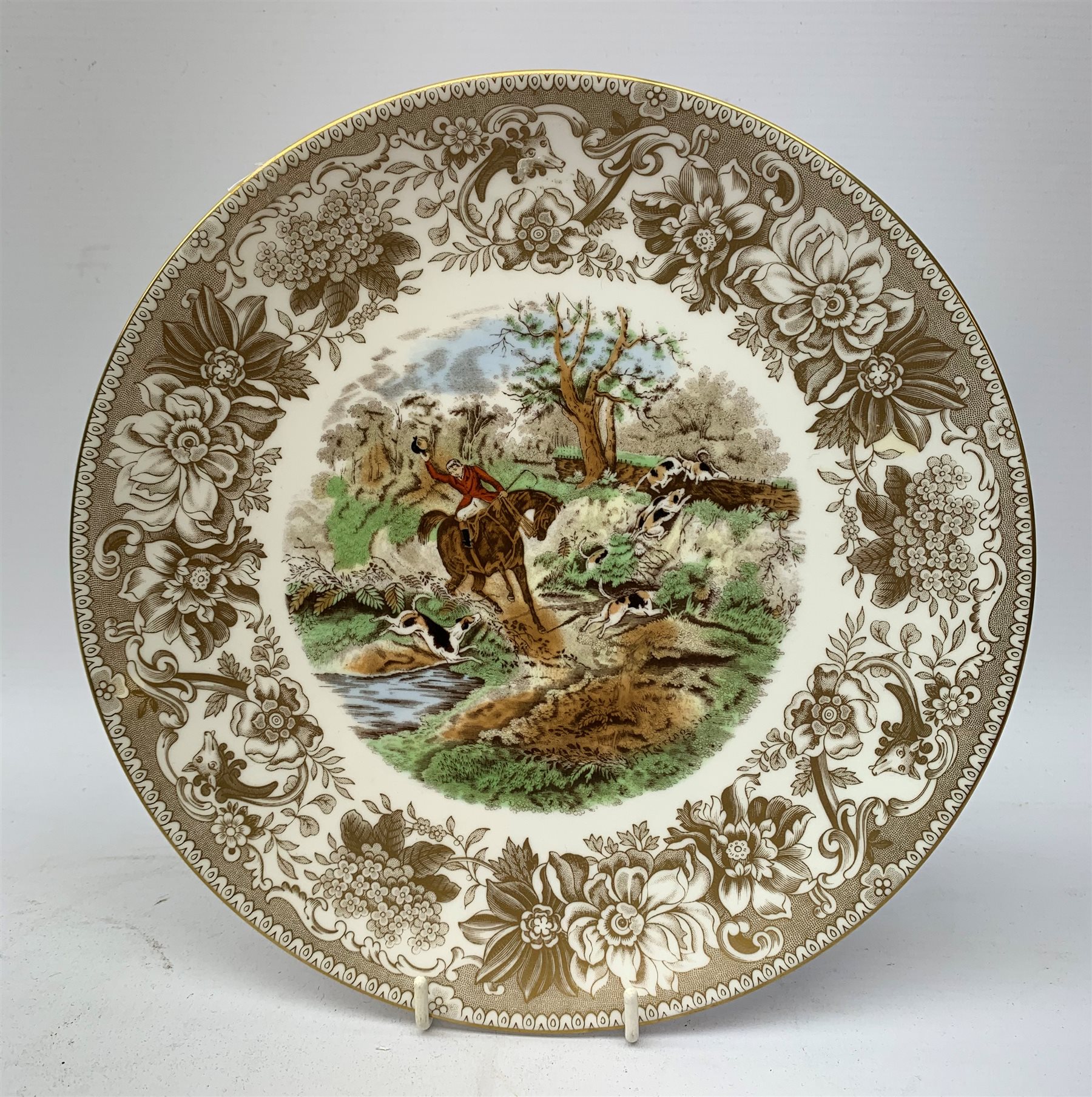  A collection of hunting related items, comprising a pair of Caverswall beakers, each with twin gilt fox head handles, H11.5cm, a limited edition Spode cabinet place depicting 'Drawing the Dingle' after J F Herring Sen, D24cm, and a set of six French shot glasses, decorated with huntsmen on horseback and hounds, H5.5cm.  