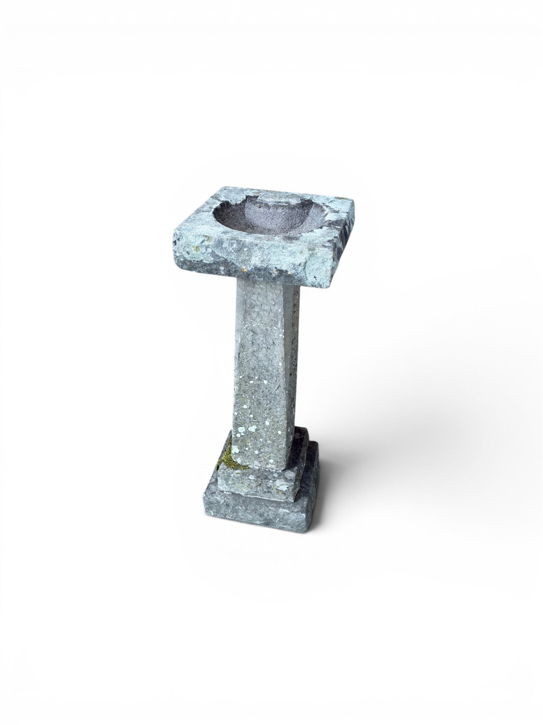 19th century weathered sandstone birdbath, formed in four sections, square top with carved shell bath, raised on tapering column with stepped base