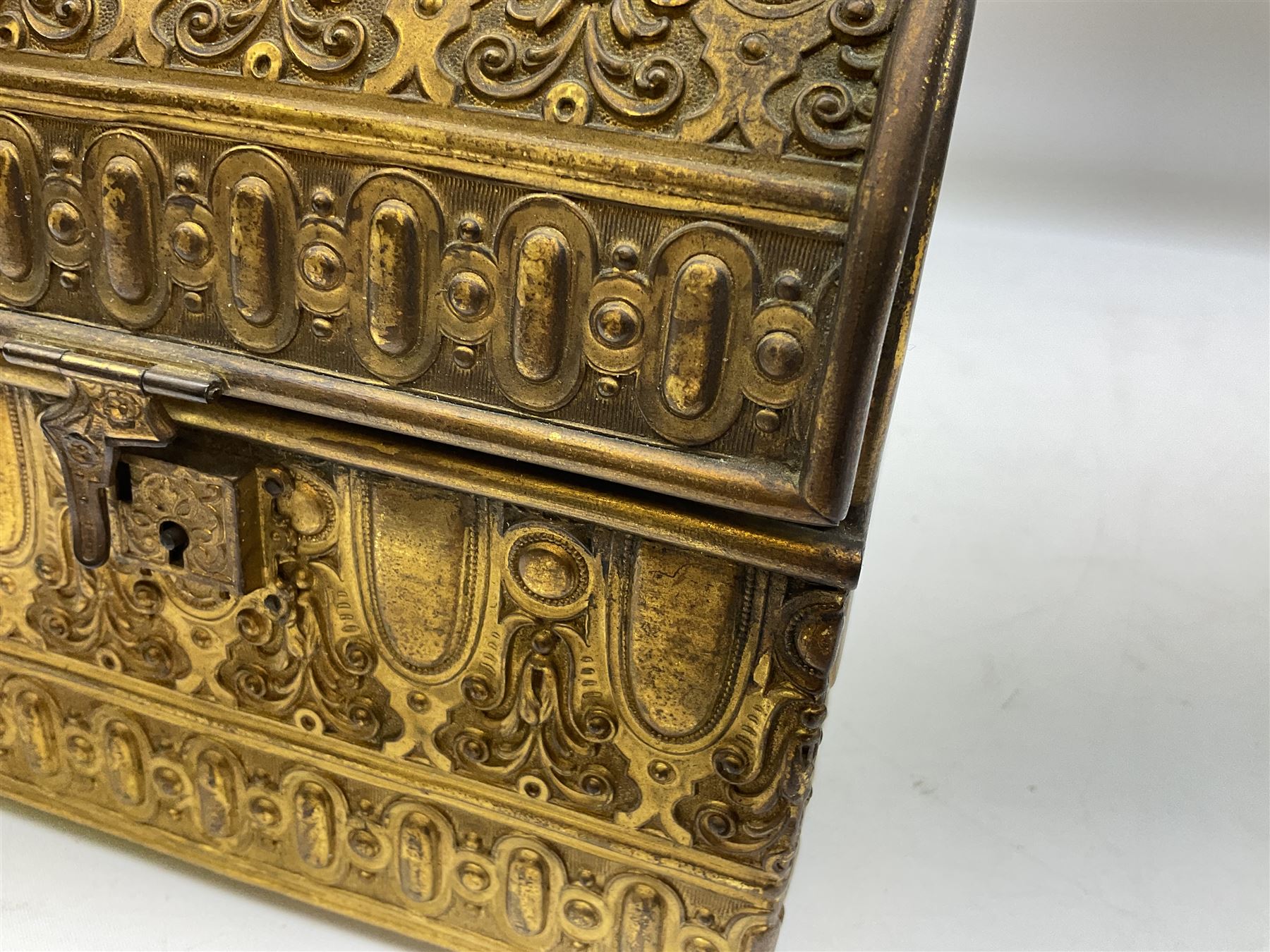 19th century brass repoussé perfume box, the ornately decorated casket with hinged domed cover lifting to reveal gold velvet lined interior containing three glass scent bottles, H14cm W15cm D7cm