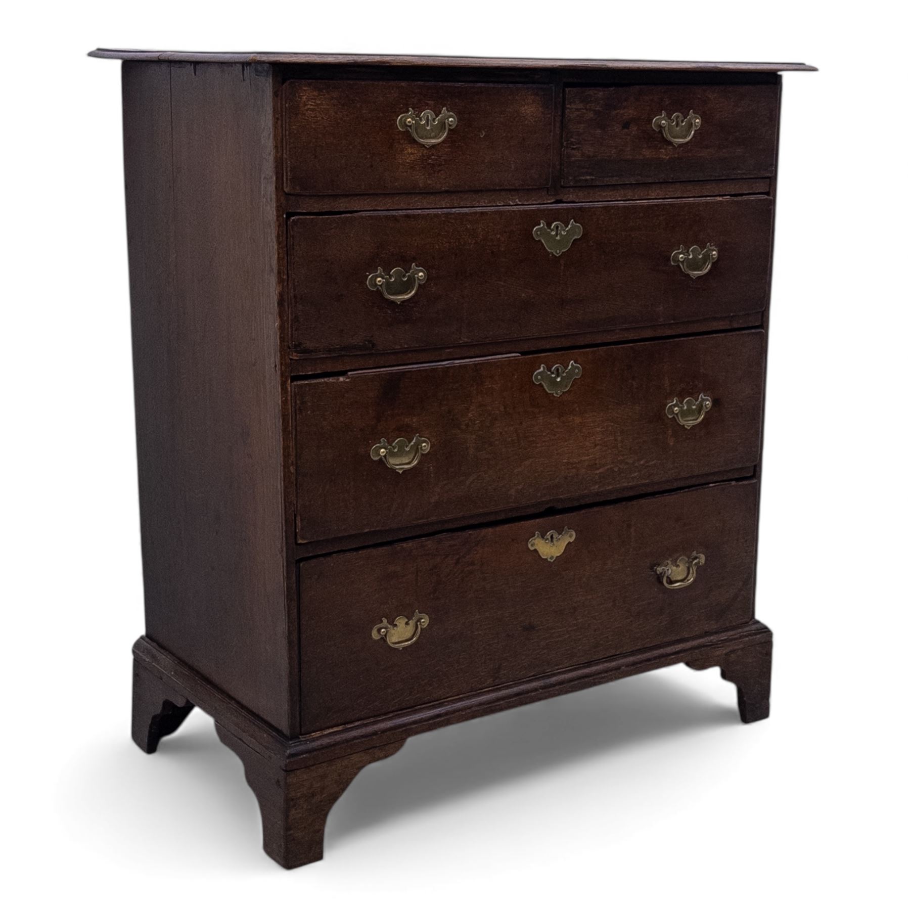 18th century oak chest, the rectangular top above an arrangement of two short over three long drawers fitted with brass batwing handles and escutcheons, raised upon shaped bracket feet