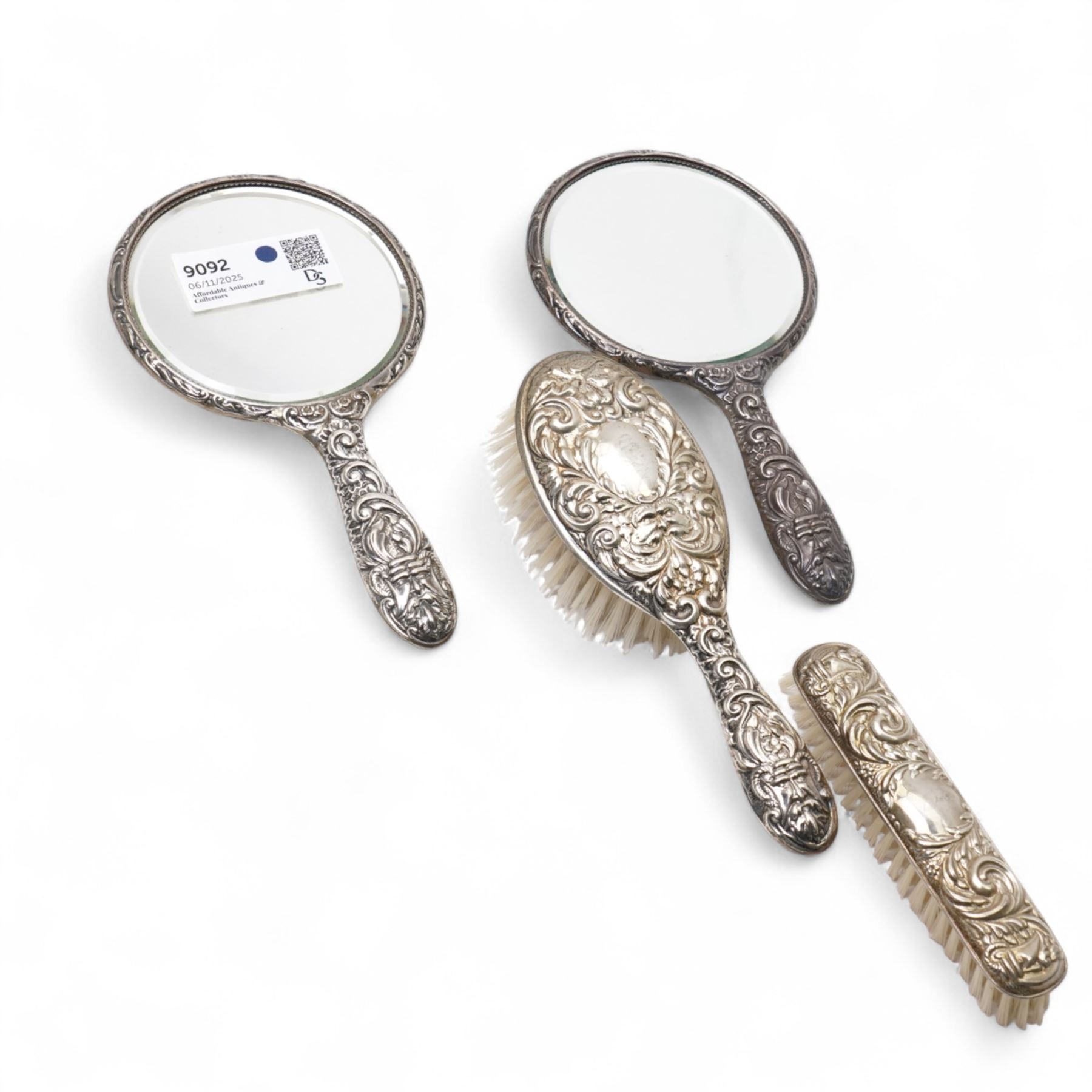 Pair of silver backed hand mirrors, clothes brush and hair brush (4)