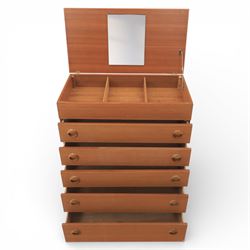 Mid 20th century teak dressing chest, rectangular top hinged to reveal a fitted interior with divisions and a rectangular mirror to the underside, over five long drawers with recessed circular handles, raised on tapering supports