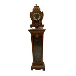 A contemporary 20th century Boulle clock case on a conforming tapered plinth with a glazed door supported on shaped bracket feet, case and plinth in birds eye maple with inlay, cast brass scroll work and fittings, with a cast brass dial with inset white cartouche  Roman numerals and glazed door, no movement or hands, with pendulum.