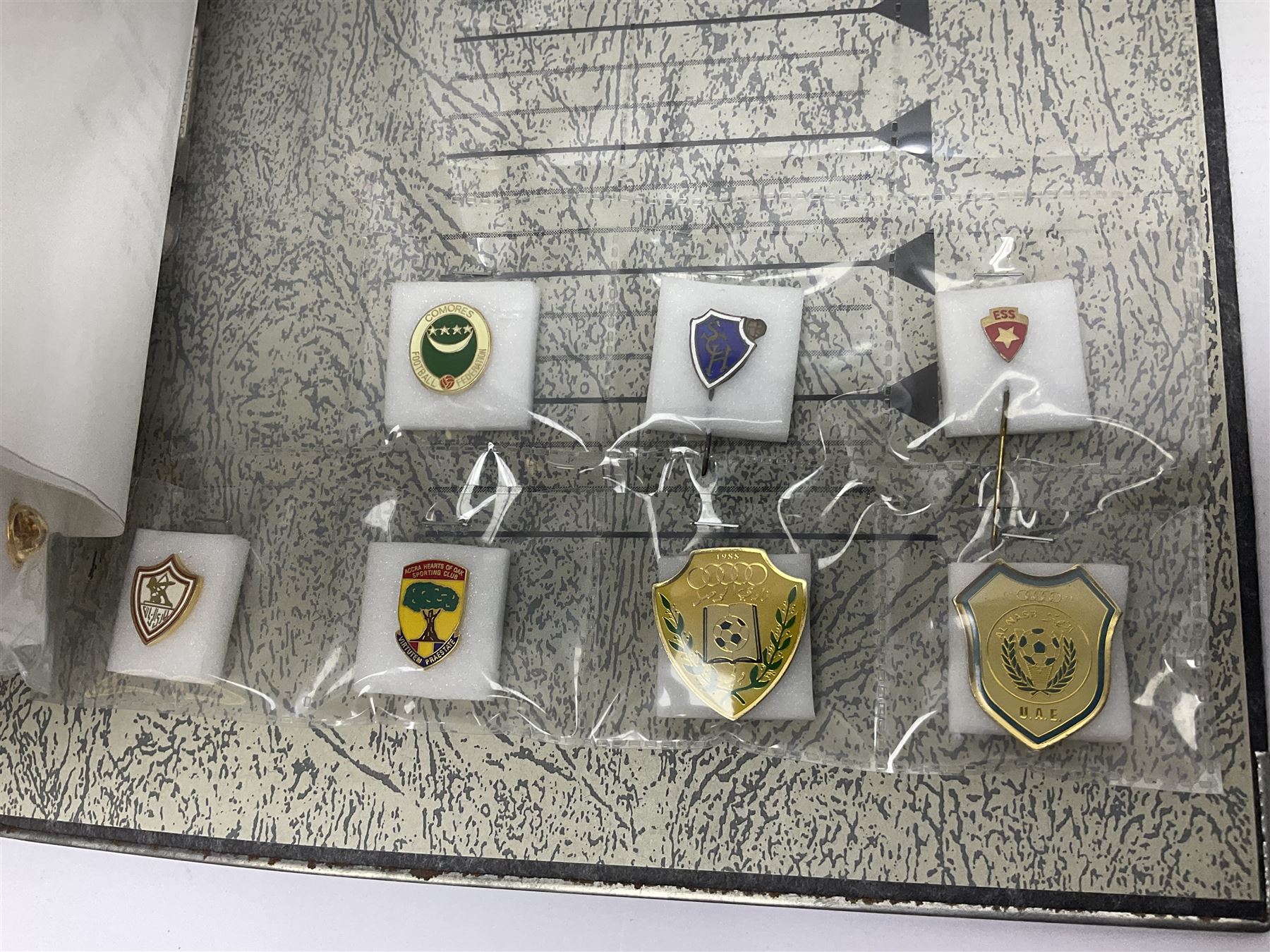 Large collection of approximately one hundred and eighty enamel badges and pins, relating to British and World football clubs, including loose examples and examples housed in folders, mostly identified