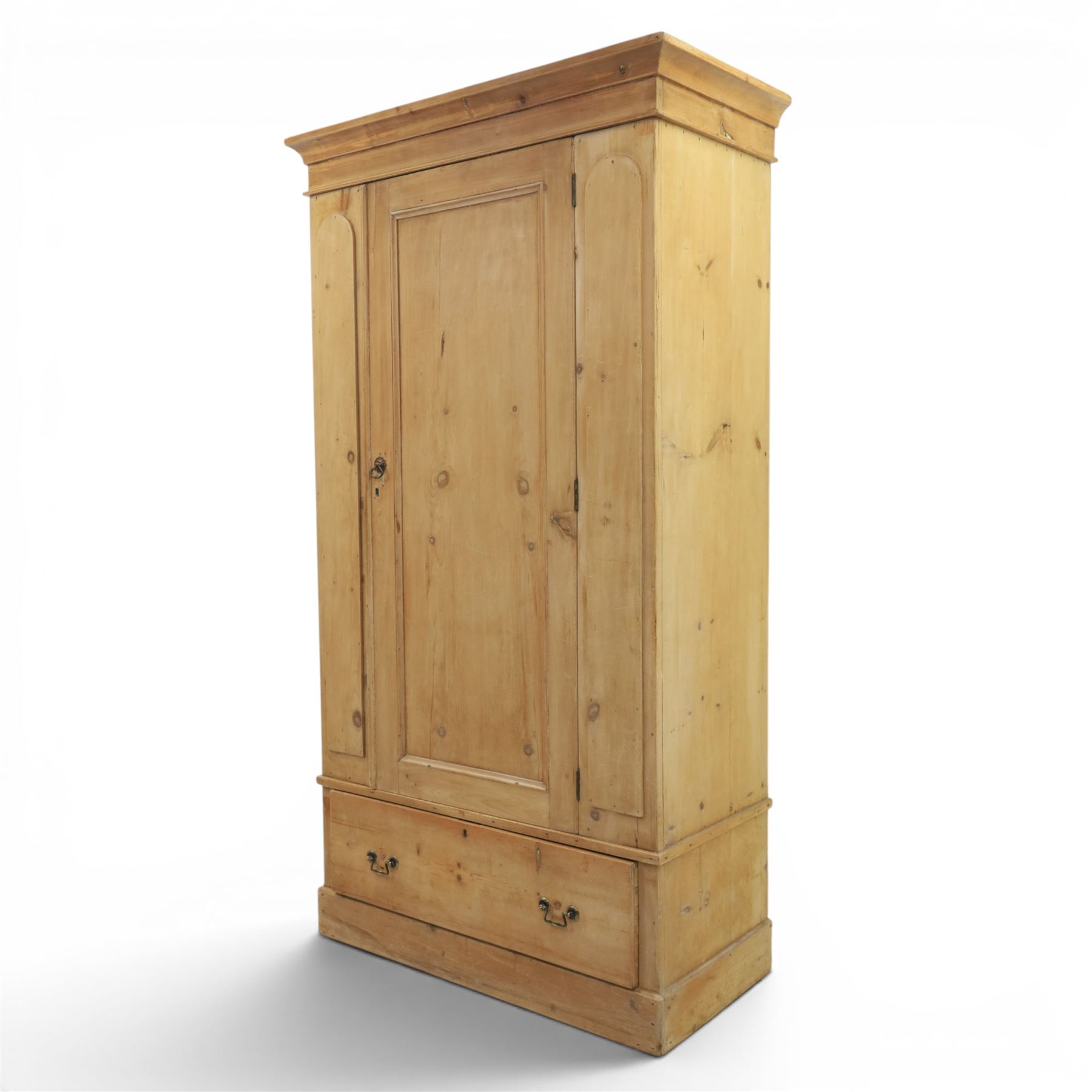 Traditional waxed pine single wardrobe, featuring single panelled door above base drawer, loop handles