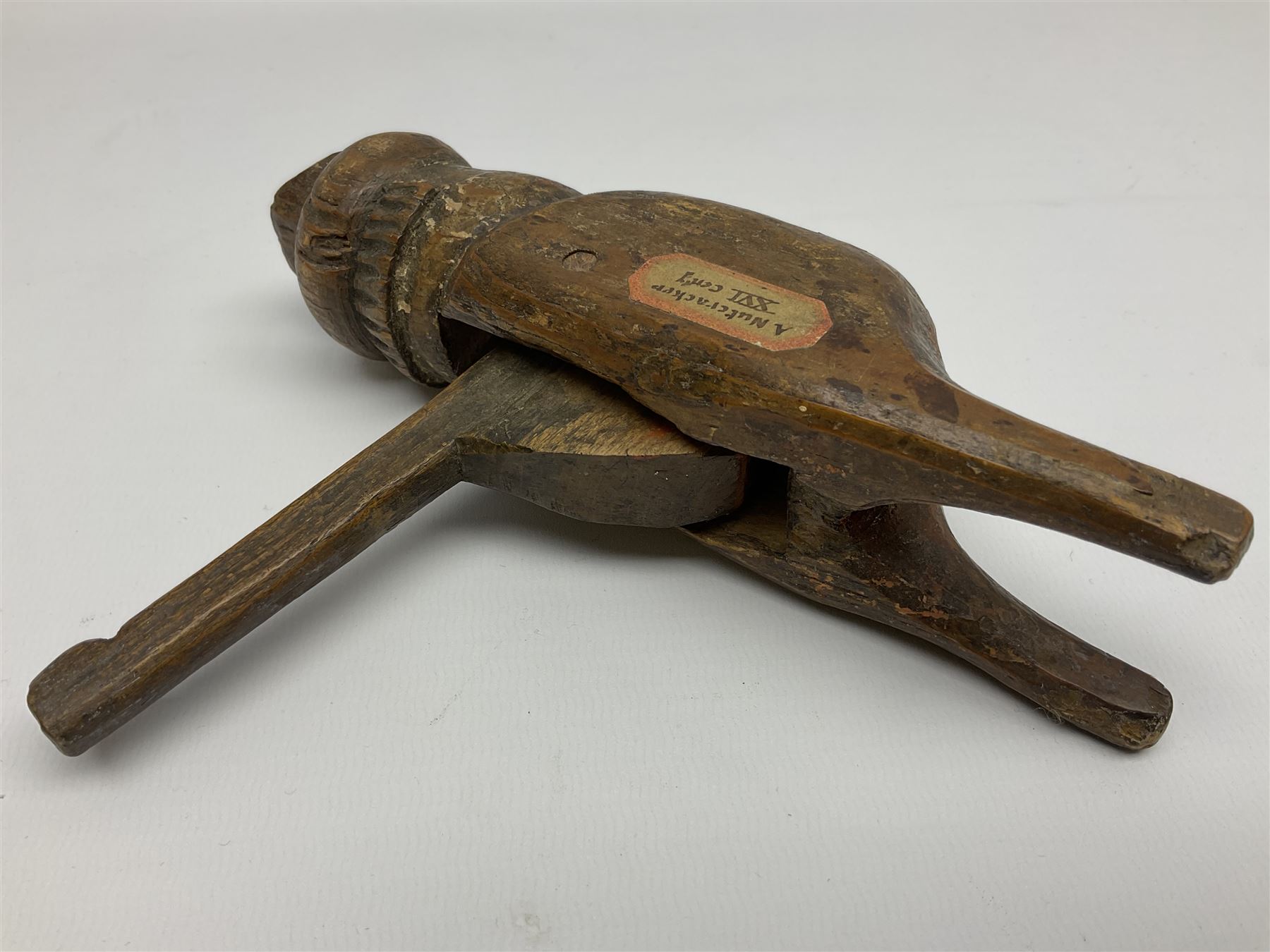 Rare primitive treen lever action nutcracker, probably late 17th/early 18th century, carved in the form of a man, with old collector label to side inscribed 'A Nutcracker XVI Century', H18cm