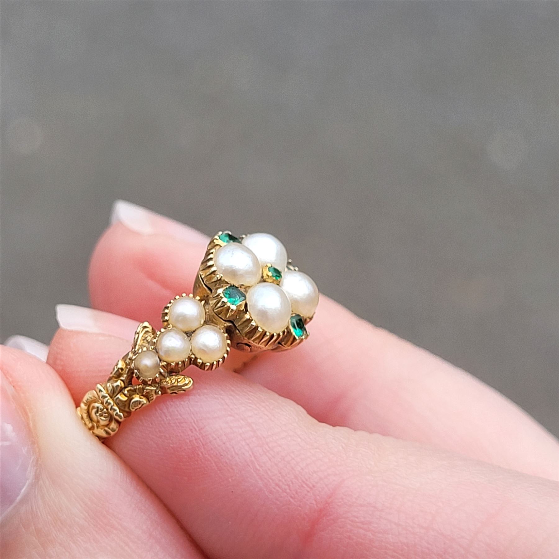 19th / early 20th century 18ct gold emerald and pearl flower head cluster ring, with pearl set shoulders and engraved foliate shank